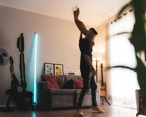 Man stretching casually at home